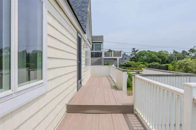 a view of balcony with wooden floor and fence