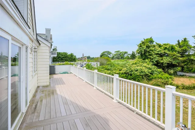 a view of a balcony with wooden floor