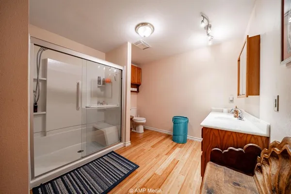 a bedroom with bed window and flat screen tv
