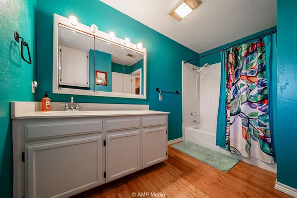 a view of a patio with table and chairs under an umbrella with a barbeque