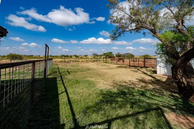 a bathroom with a sink mirror and view of ocean