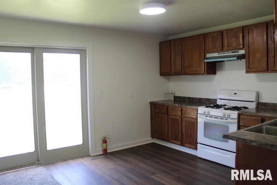 632 East 9th Street Kewanee, IL 61443 - Photo 12 of 36 a kitchen with granite countertop wooden floors and stainless steel appliances