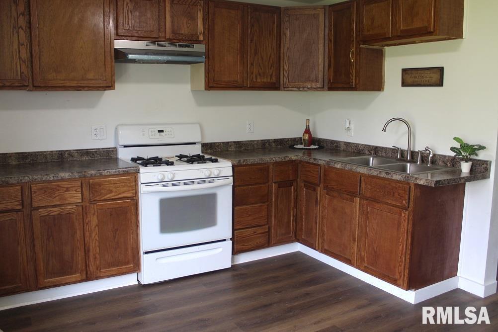 632 East 9th Street Kewanee, IL 61443 - Photo 7 of 36 a kitchen with granite countertop wood cabinets and white appliances