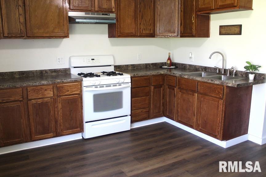 632 East 9th Street Kewanee, IL 61443 - Photo 8 of 36 a kitchen with a sink cabinets and wooden floor