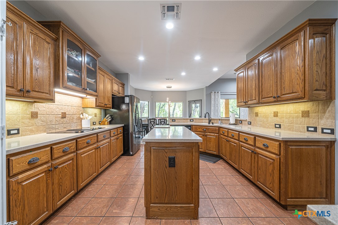 519 Long Meadow Spring Branch, TX 78070 - Photo 13 of 33 a kitchen with stainless steel appliances granite countertop a sink and cabinets