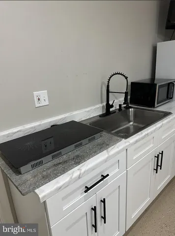 a bathroom with a sink a toilet and a shower