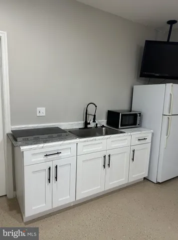 a bathroom with a sink a toilet a mirror and shower