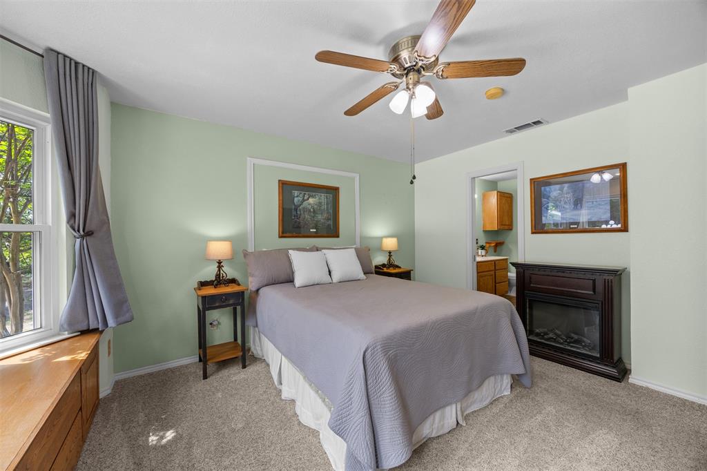 881 Wild Road Van Alstyne, TX 75495 - Photo 18 of 40 a bedroom with a bed and a chandelier