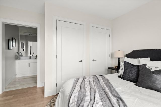 a bedroom with a bed and cabinets