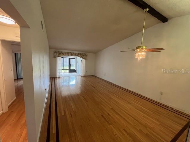 1725 Pine Ridge Way East, Unit C Palm Harbor, FL 34684 - Photo 12 of 28 wooden floor in an empty room with a window