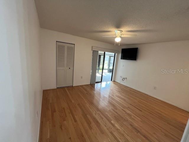 1725 Pine Ridge Way East, Unit C Palm Harbor, FL 34684 - Photo 15 of 28 a view of empty room with wooden floor and fan