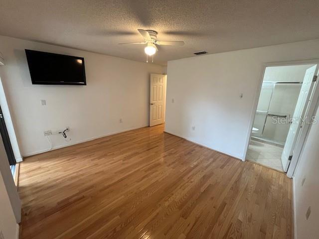 1725 Pine Ridge Way East, Unit C Palm Harbor, FL 34684 - Photo 16 of 28 wooden floor in an empty room with a window