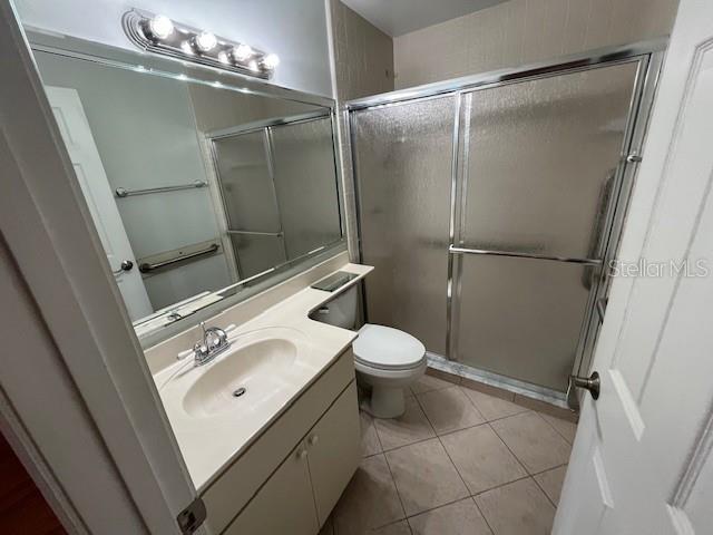 1725 Pine Ridge Way East, Unit C Palm Harbor, FL 34684 - Photo 18 of 28 a bathroom with a sink a toilet and shower