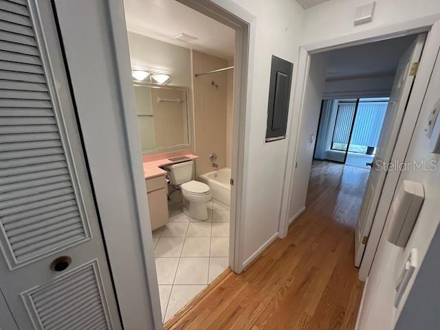 1725 Pine Ridge Way East, Unit C Palm Harbor, FL 34684 - Photo 19 of 28 a bathroom with a sink and glass door