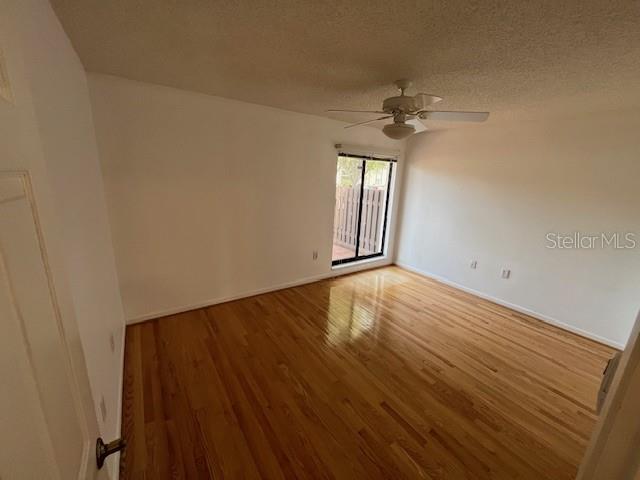 1725 Pine Ridge Way East, Unit C Palm Harbor, FL 34684 - Photo 20 of 28 wooden floor in an empty room