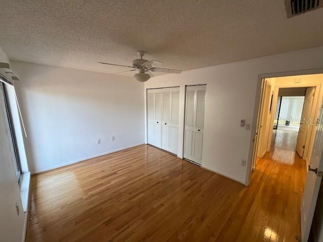 1725 Pine Ridge Way East, Unit C Palm Harbor, FL 34684 - Photo 21 of 28 a view of empty room with wooden floor