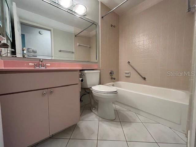 1725 Pine Ridge Way East, Unit C Palm Harbor, FL 34684 - Photo 22 of 28 a bathroom with a toilet sink and mirror