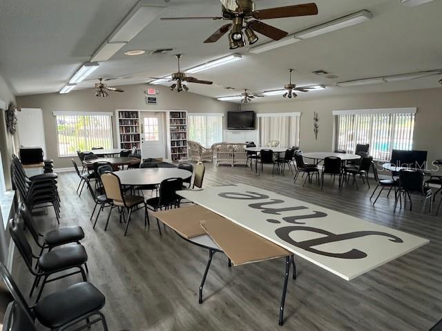 1725 Pine Ridge Way East, Unit C Palm Harbor, FL 34684 - Photo 26 of 28 a living room with lots of furniture a table and chairs