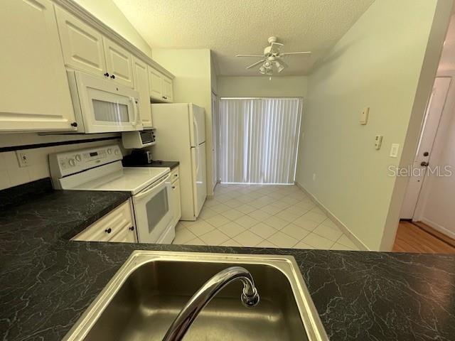 1725 Pine Ridge Way East, Unit C Palm Harbor, FL 34684 - Photo 6 of 28 a bathroom with a sink a mirror and a bathtub