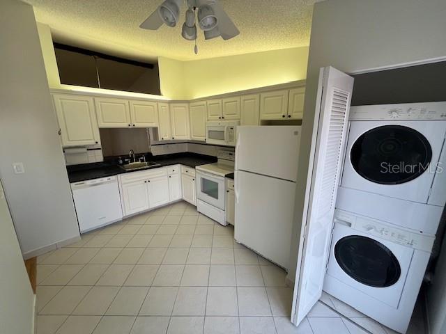 1725 Pine Ridge Way East, Unit C Palm Harbor, FL 34684 - Photo 9 of 28 a kitchen with stainless steel appliances a refrigerator sink and cabinets