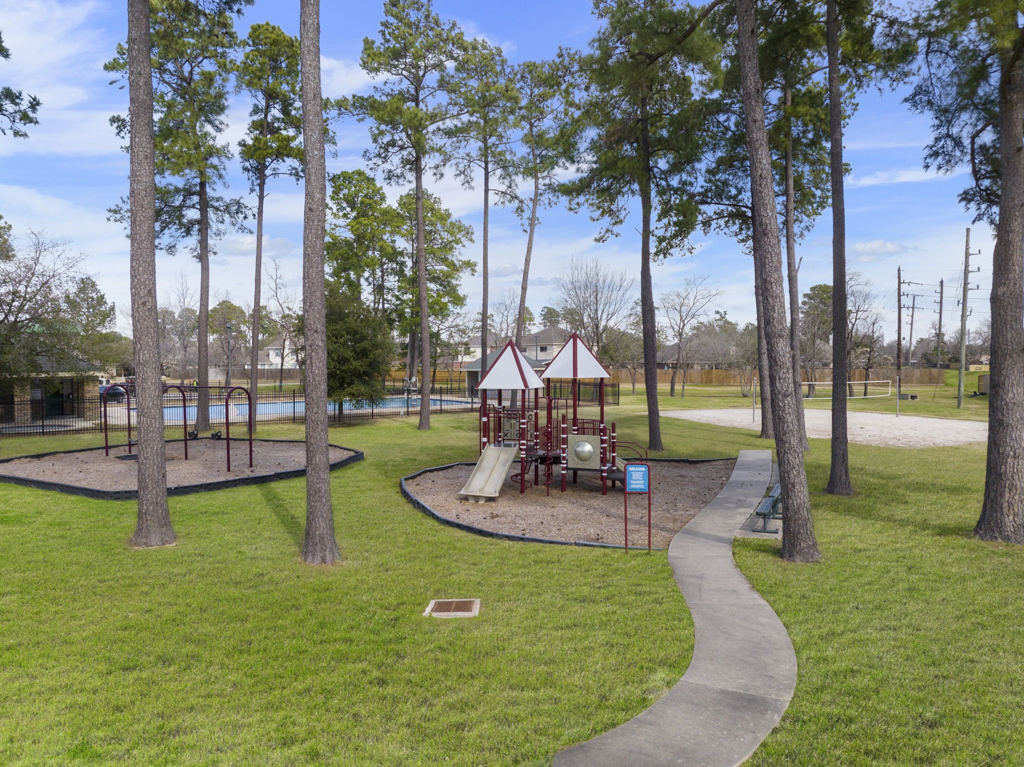 2819 Bradbury Hills Road Spring, TX 77373 - Photo 49 of 50 Nestled among towering trees, this vibrant community playground offers a delightful escape for families, complete with engaging play structures and scenic surroundings.