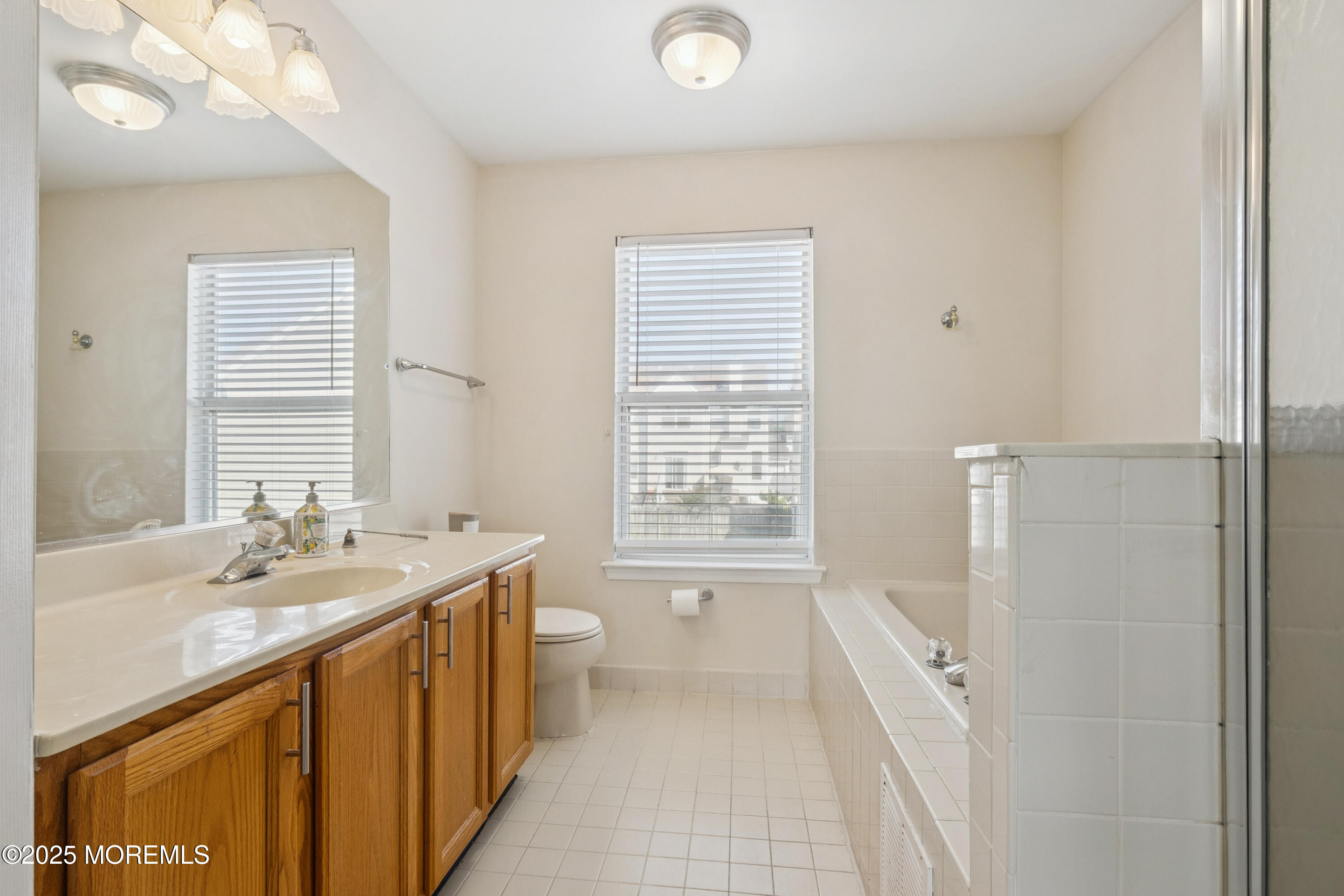 7 Devonshire Drive Hazlet, NJ 07730 - Photo 11 of 19 a bathroom with a sink a mirror and a bathtub