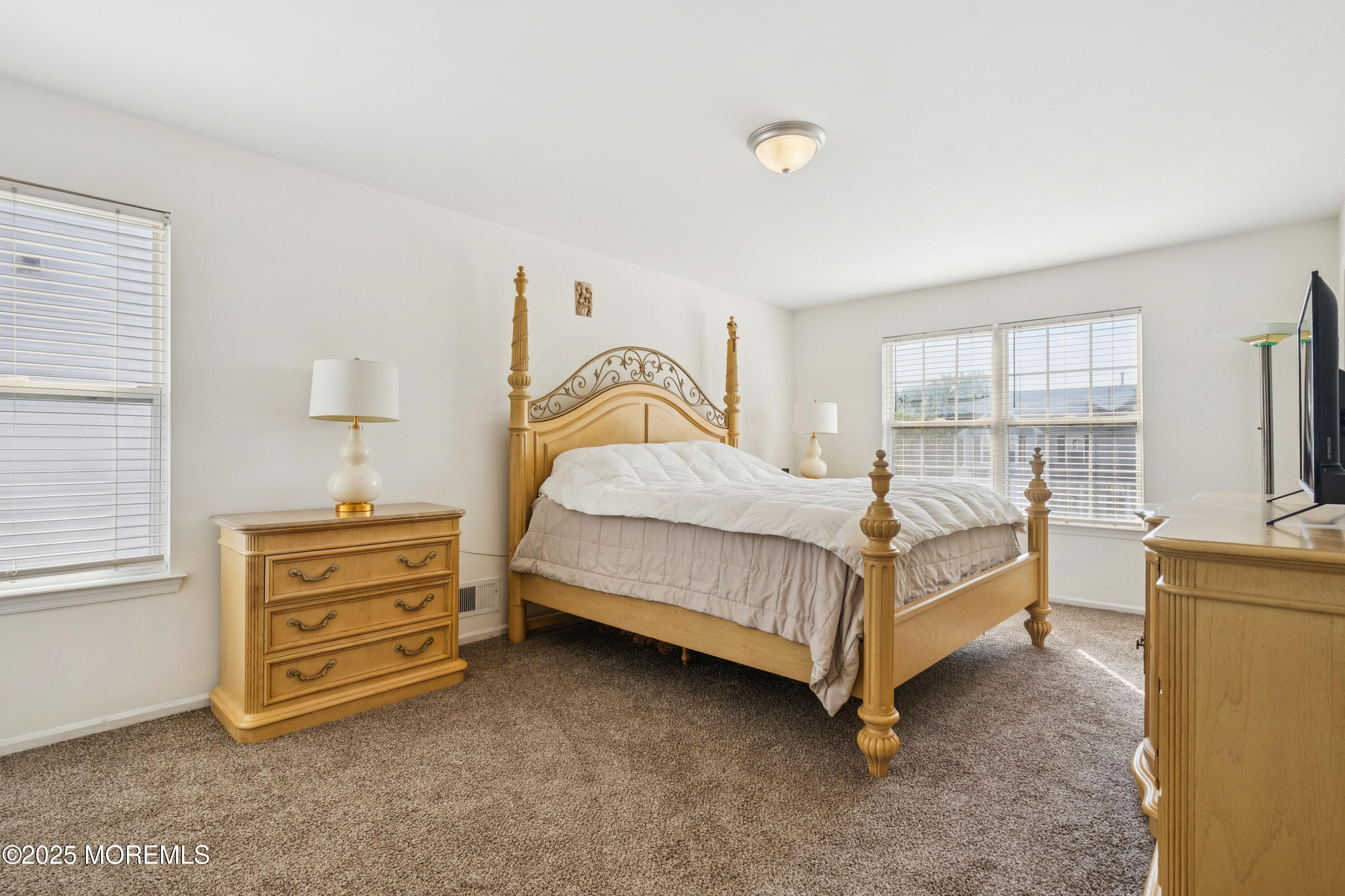 7 Devonshire Drive Hazlet, NJ 07730 - Photo 10 of 19 a bedroom with a bed and a dresser next to a window
