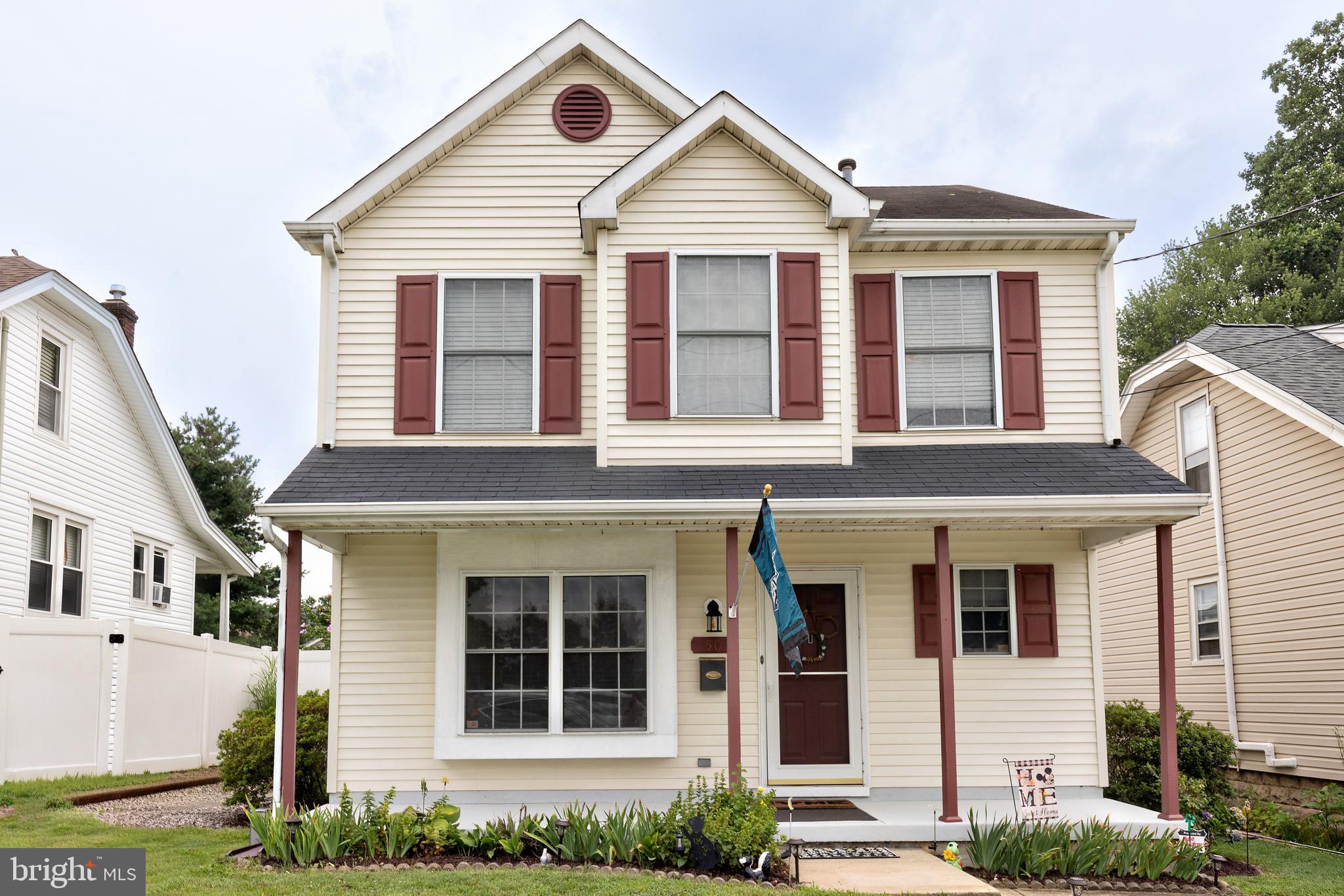 a front view of a house with plants