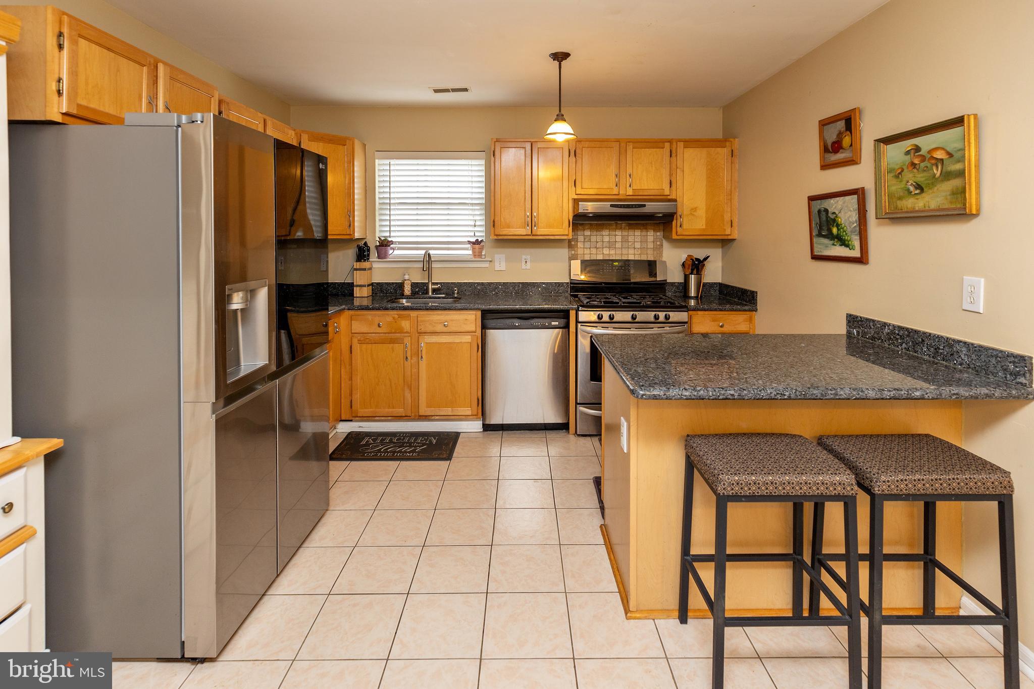 50 Haverford Road Runnemede, NJ 08078 - Photo 13 of 34 a kitchen with stainless steel appliances granite countertop a refrigerator and a stove top oven