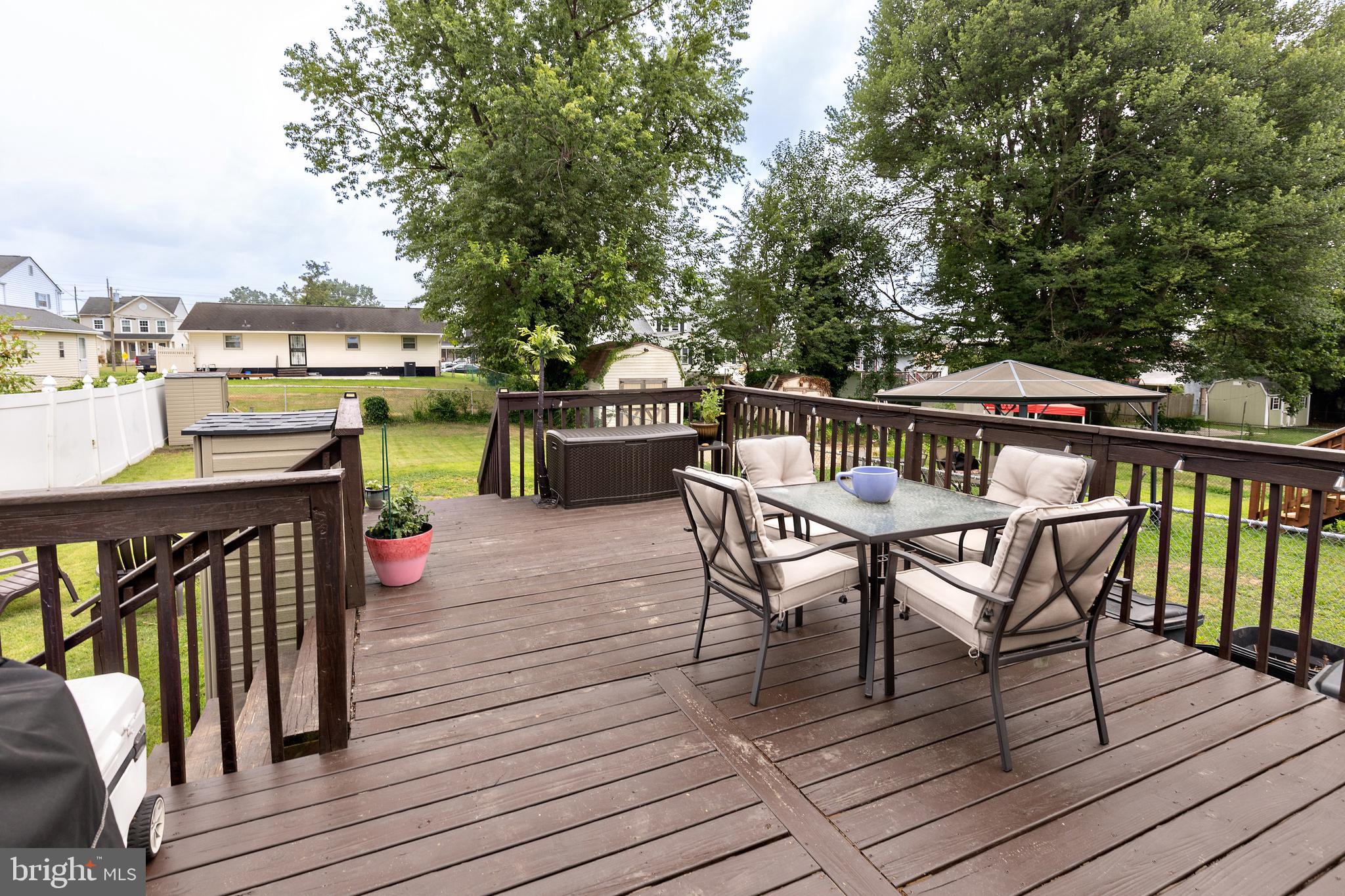 50 Haverford Road Runnemede, NJ 08078 - Photo 5 of 34 a view of a roof deck with table and chairs a barbeque with wooden floor and fence