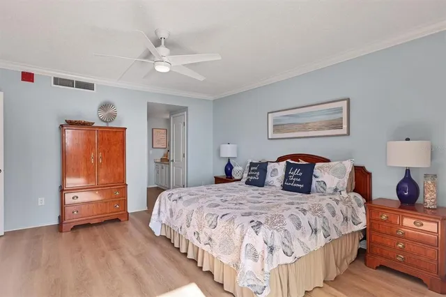 a bedroom with a large bed and a chandelier