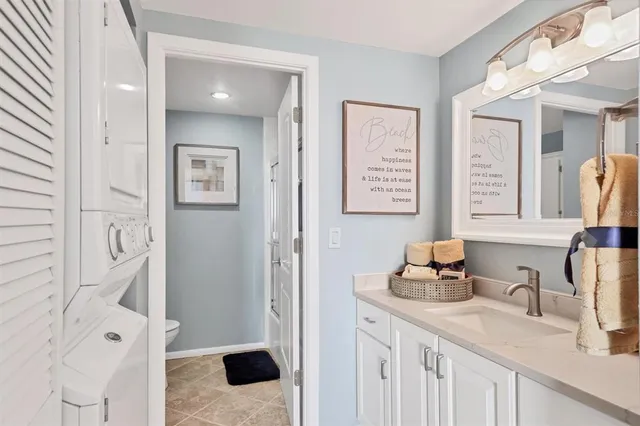 a bathroom with a sink vanity granite and a mirror