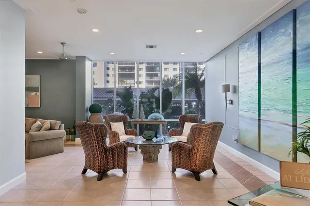 a dining room with furniture and a floor to ceiling window