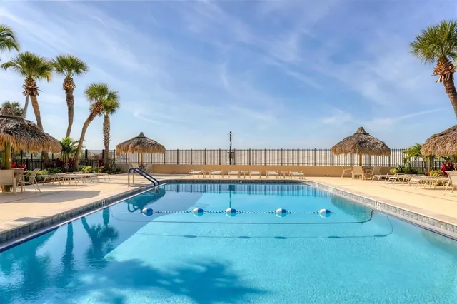 a view of swimming pool with outdoor seating and a garden