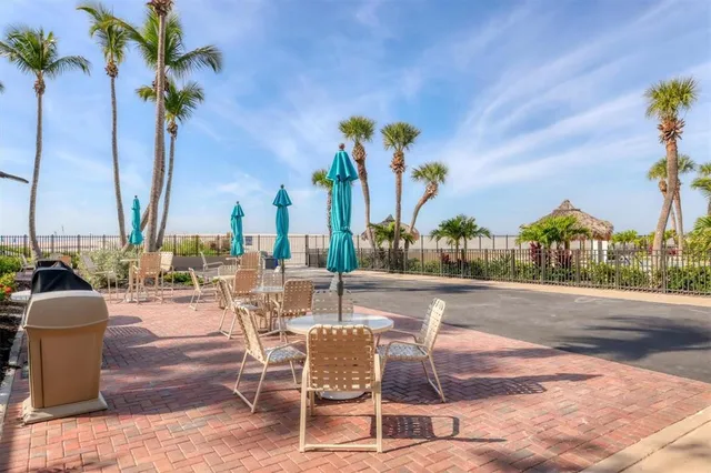 a view of a patio with a dining table and chairs with wooden floor