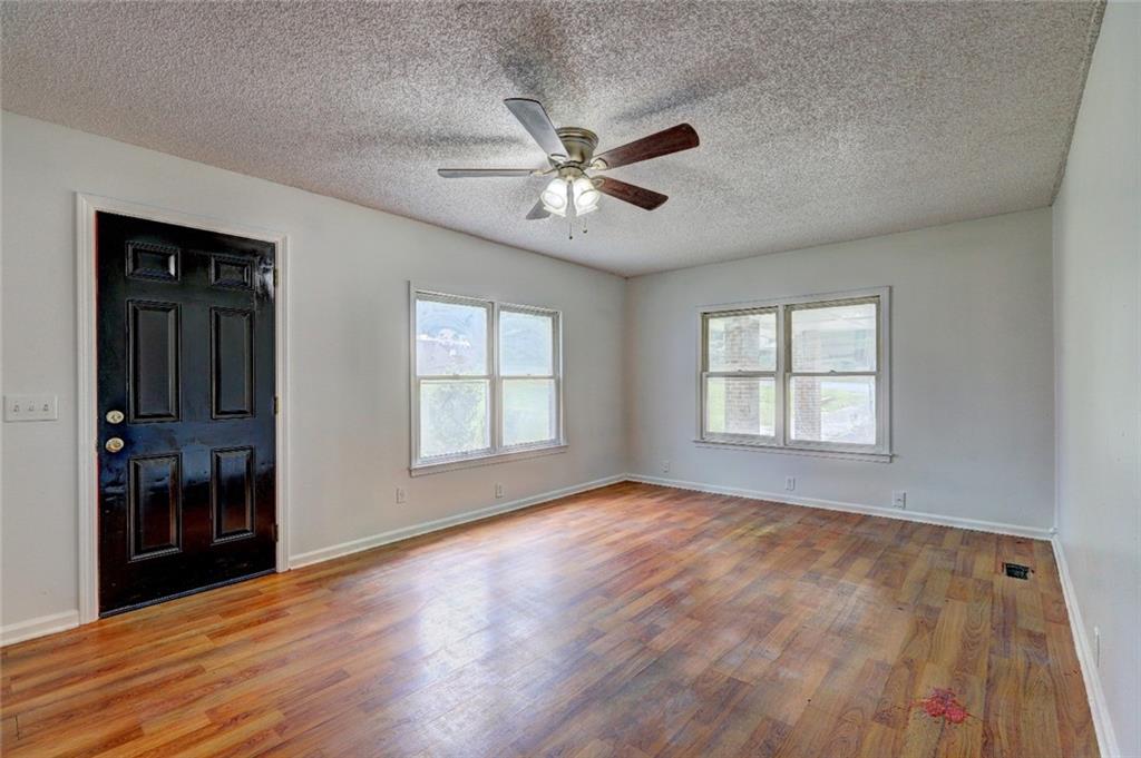 3266 Betty Place Macon, GA 31217 - Photo 5 of 10 a view of an empty room with window and wooden floor