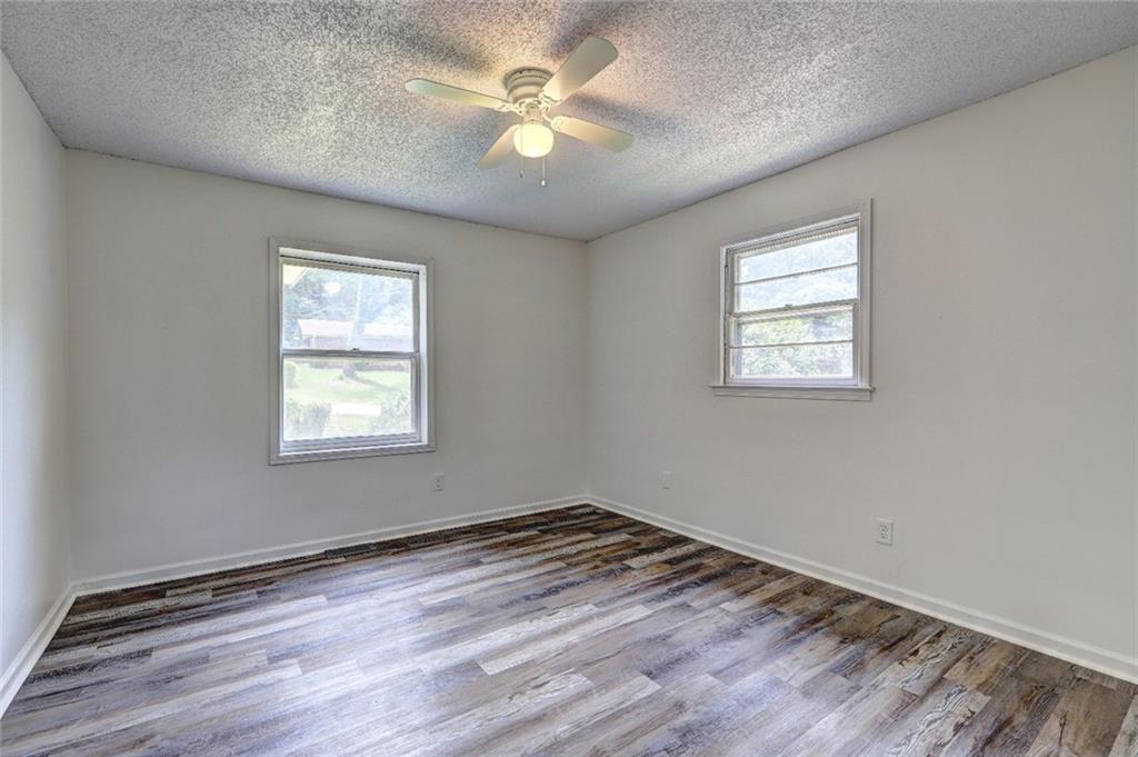 3266 Betty Place Macon, GA 31217 - Photo 8 of 10 an empty room with wooden floor and windows