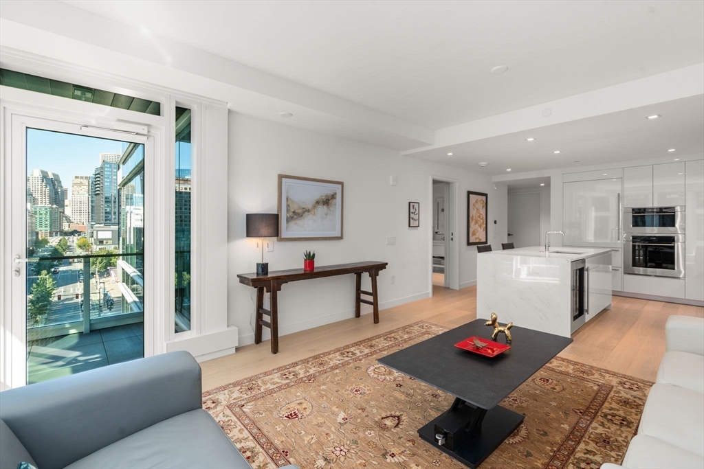 150 Seaport Boulevard, Unit 8A Boston, MA 02210 - Photo 8 of 27 a living room with furniture and wooden floor
