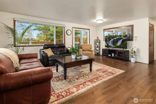 a living room with furniture large window and a table