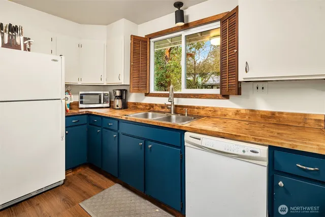 a kitchen with stainless steel appliances granite countertop a refrigerator sink and cabinets