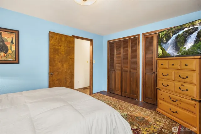 a bedroom with a bed and a dresser