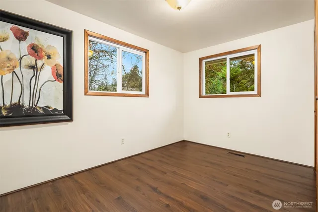 wooden floor in a empty room with a window