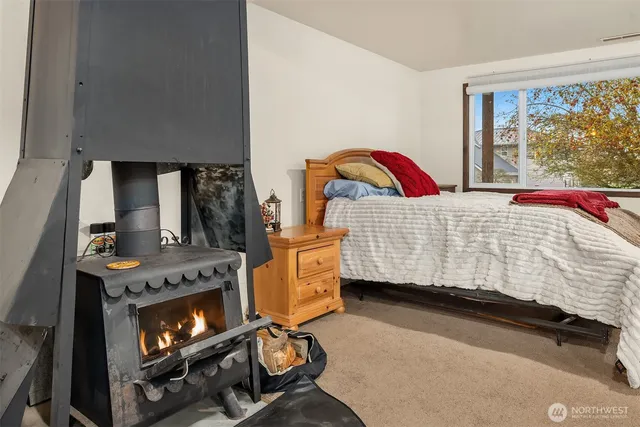 a bedroom with a bed and a fireplace