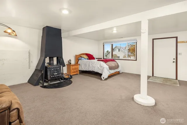 a living room with furniture gym equipment and a large window