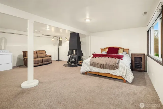 a bedroom with bed and a large window