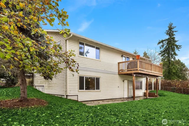 a view of a house with a yard and a garden