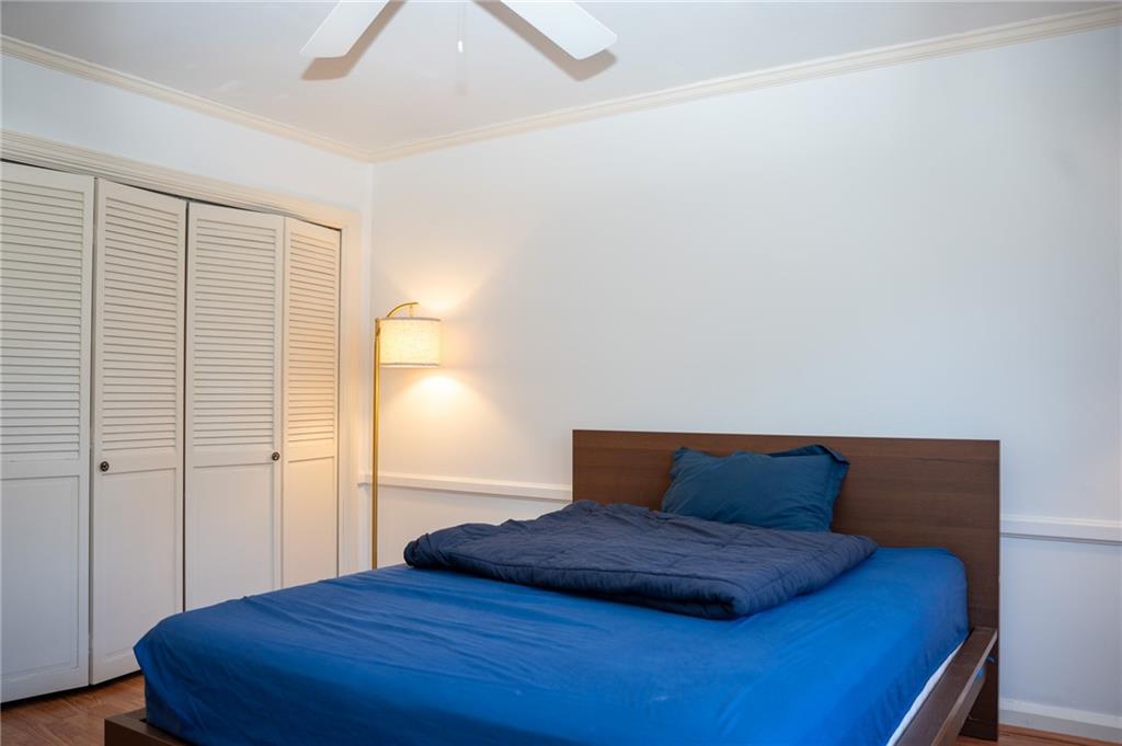 5025 Fifth Avenue, Unit 3F Pittsburgh, PA 15232 - Photo 12 of 22 a bedroom with a bed and wooden floor