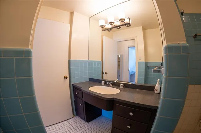 a bathroom with a sink a mirror and a shower