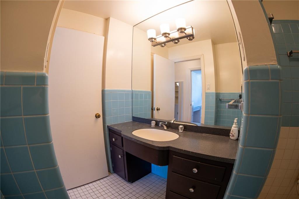 5025 Fifth Avenue, Unit 3F Pittsburgh, PA 15232 - Photo 14 of 22 a bathroom with a sink a mirror and a shower
