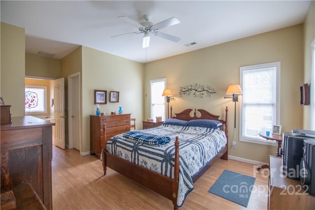 7 Sheffield Place Brevard, NC 28712 - Photo 11 of 30 a bedroom with a bed and a chandelier